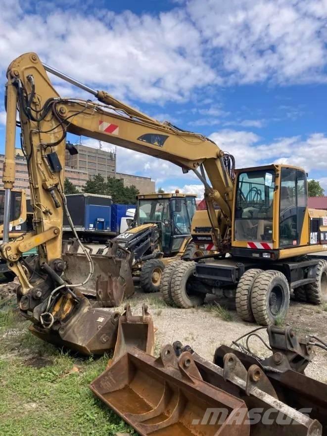 CAT M 312 Ratiniai ekskavatoriai