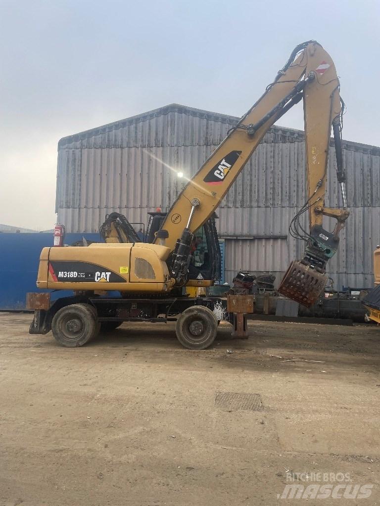 CAT 318 dmh Krovimas/Kėlimas - Kita