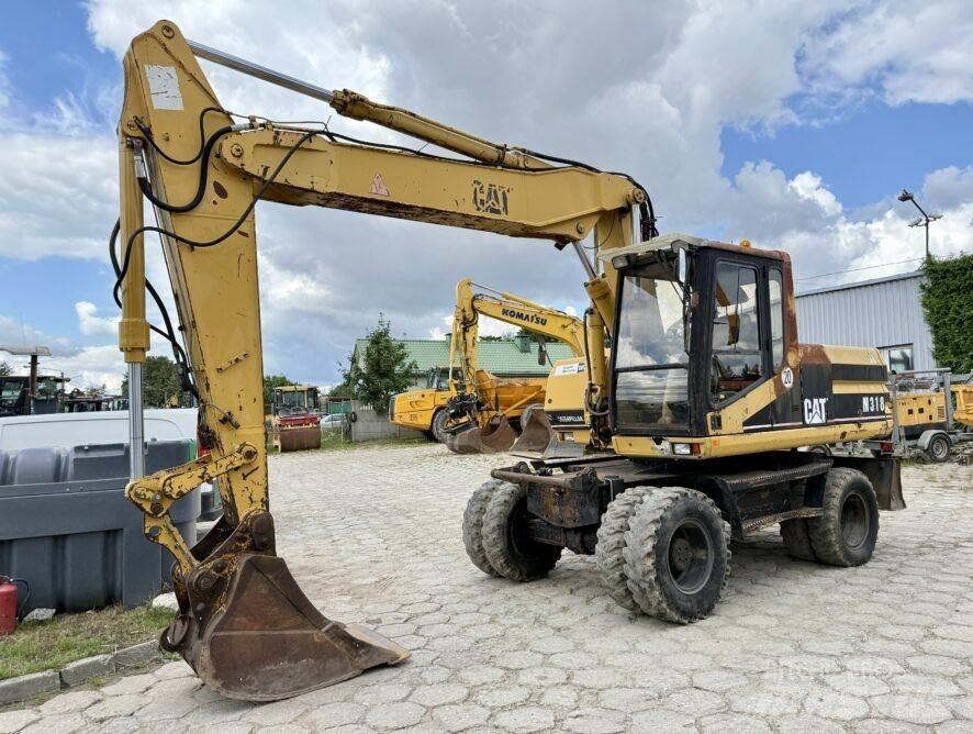 CAT M318 Ratiniai ekskavatoriai